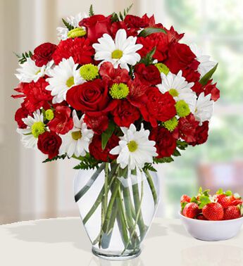 4 stems of White and 2 stems of Green Chrysanthemums , 6 Red Carnations , 5 Red Roses in a Glass Vase (one sided round arrangement) Simply Irresistible