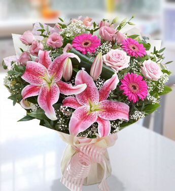 Bunch of 3 Dark Pink Gerbera, 3 stems of Pink Lily (Approx 9 Flowers), 3 Pink Rose in nice wrapping Contemporary Feel