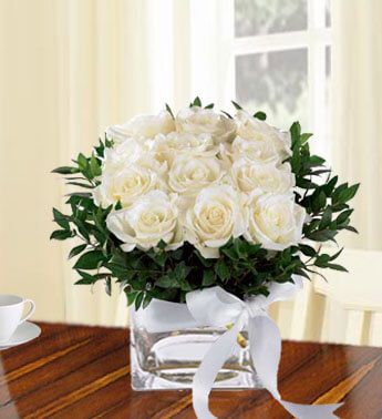 12 White Roses with greens in a cube vase. Remembrance 12
