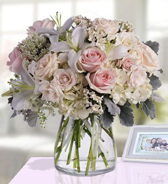 Vase with 3 stems of White Lilies , 10 Stem of Peach Roses , 3 stems of White Alstromeria , 1 stems of White Hydrangeas & Fillers(One side Round arrangement) Style & Simplicity