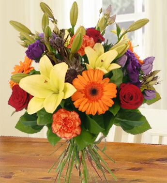 Bunch of 2 stems of Yellow Lilies ,3 Red Roses ,3 Orange Carnations & 3 Orange Gerberas in nice wrapping All For You
